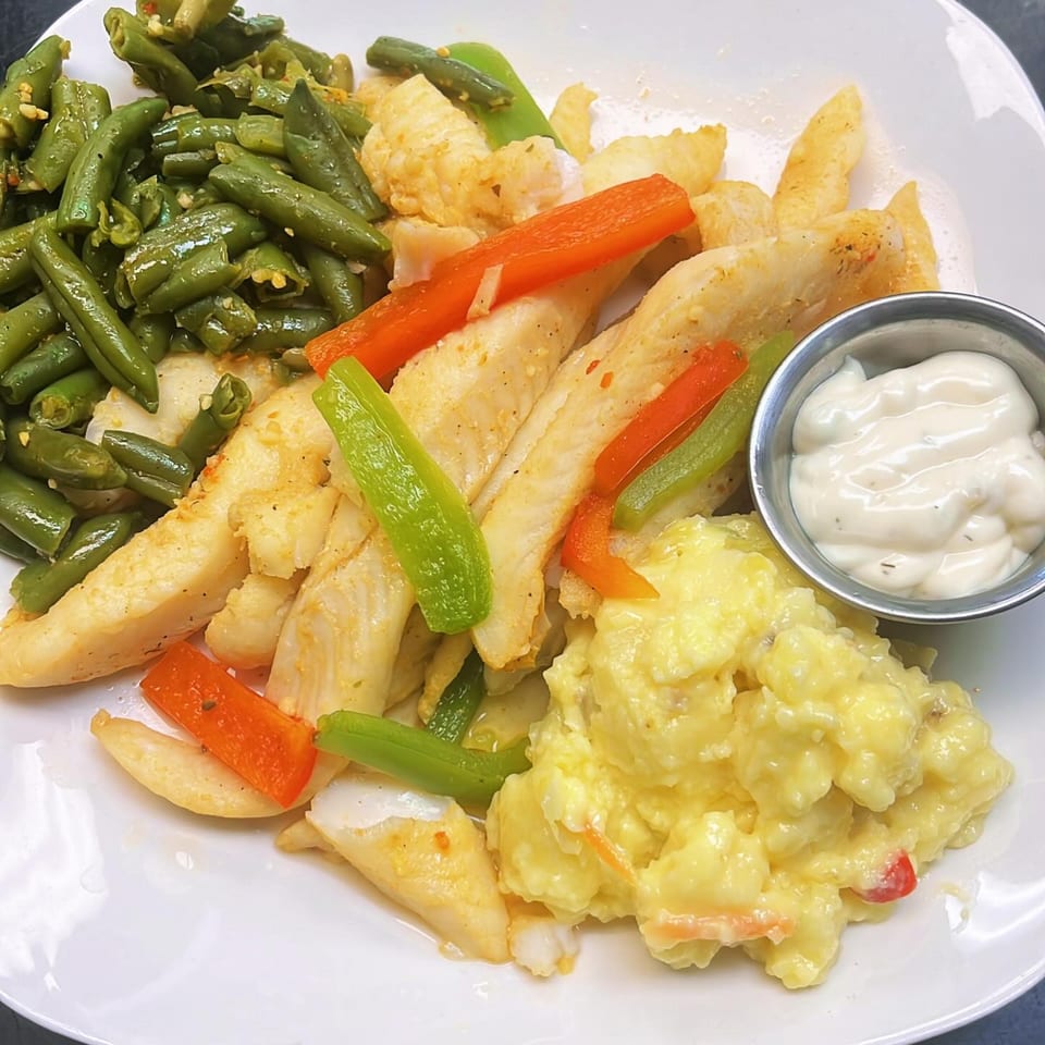 Lutfi’s Raymore seafood platter with fish, green beans, potato salad, and tartar sauce.